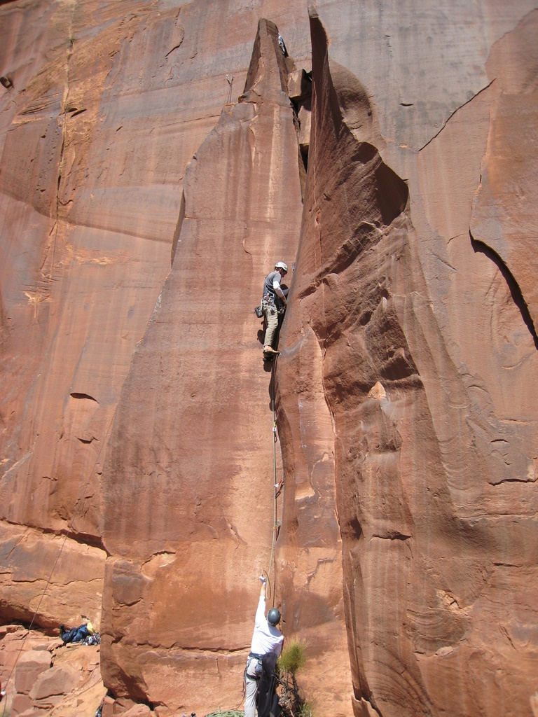 Matt L. leads an unnamed 5.10 offwidth, left of Wavy Gravy, on Scarface Cliff